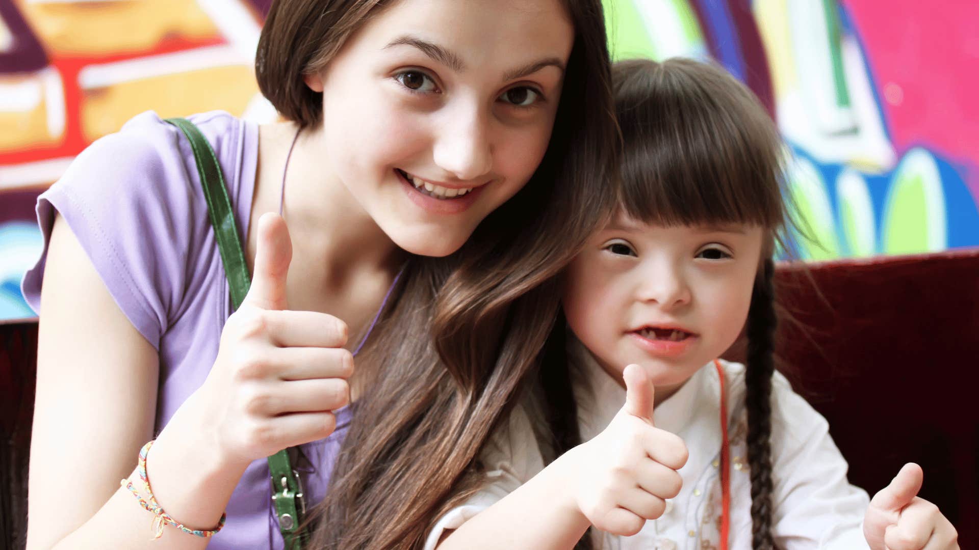 Woman and child give thumbs up