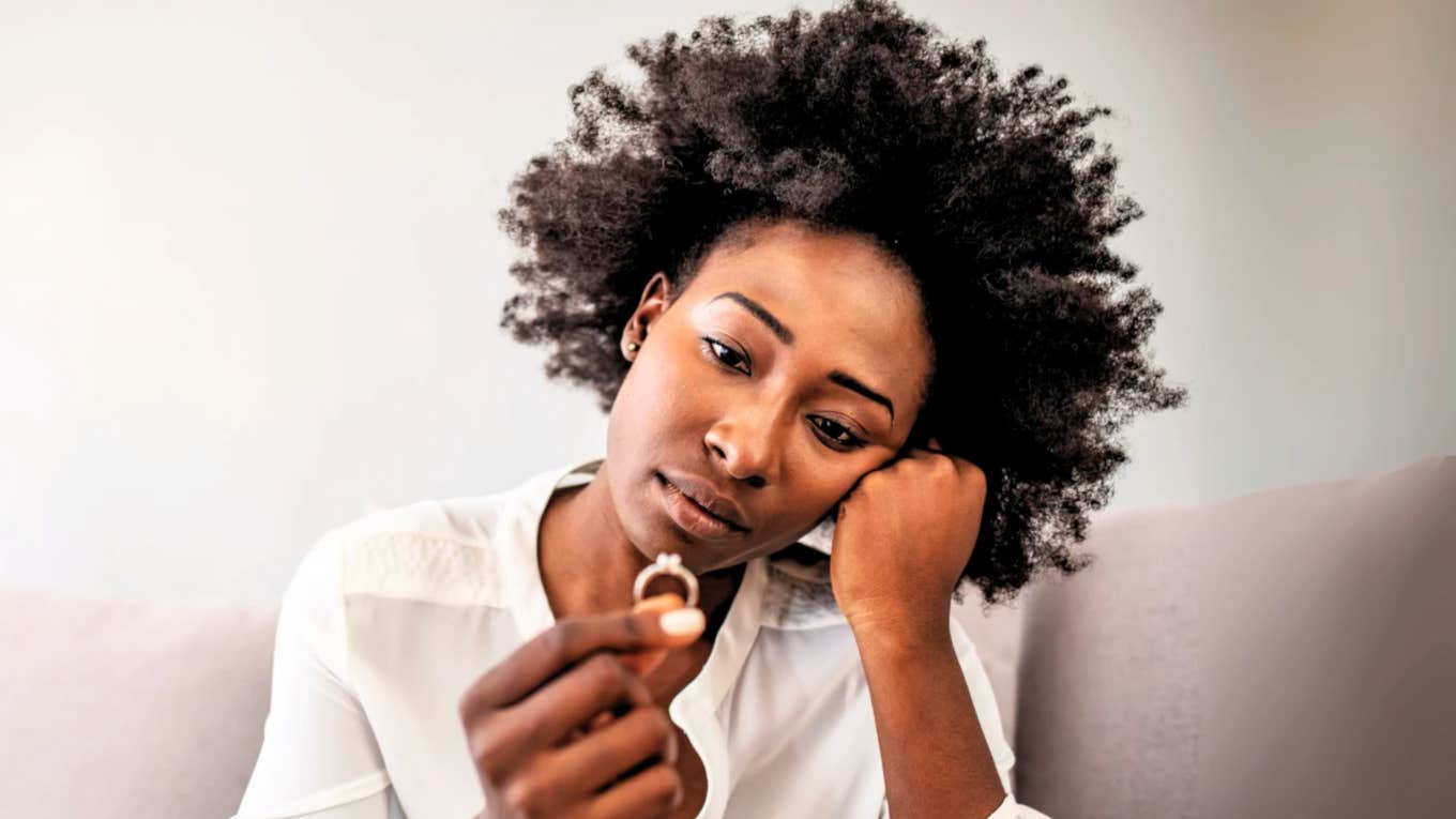 Woman looks at her ring sadly because she believed common marriage myths