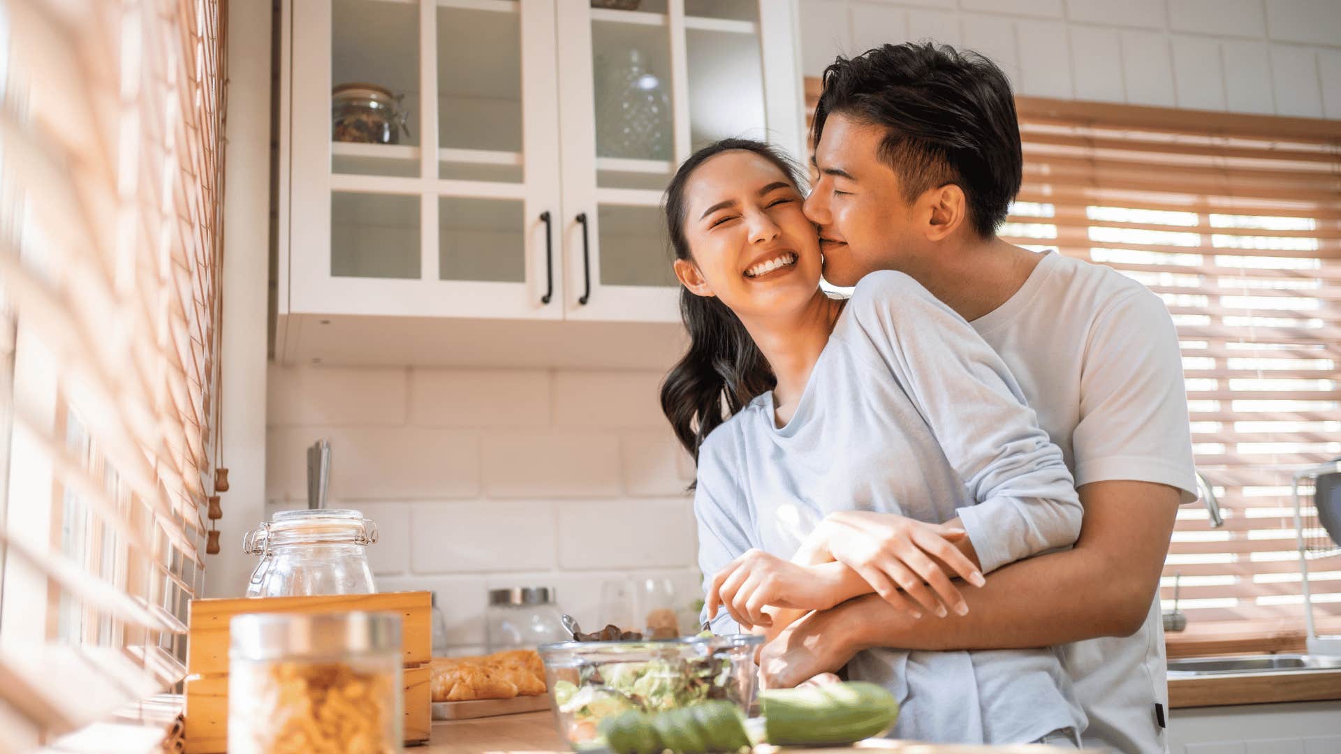 man hugging woman in kitchen