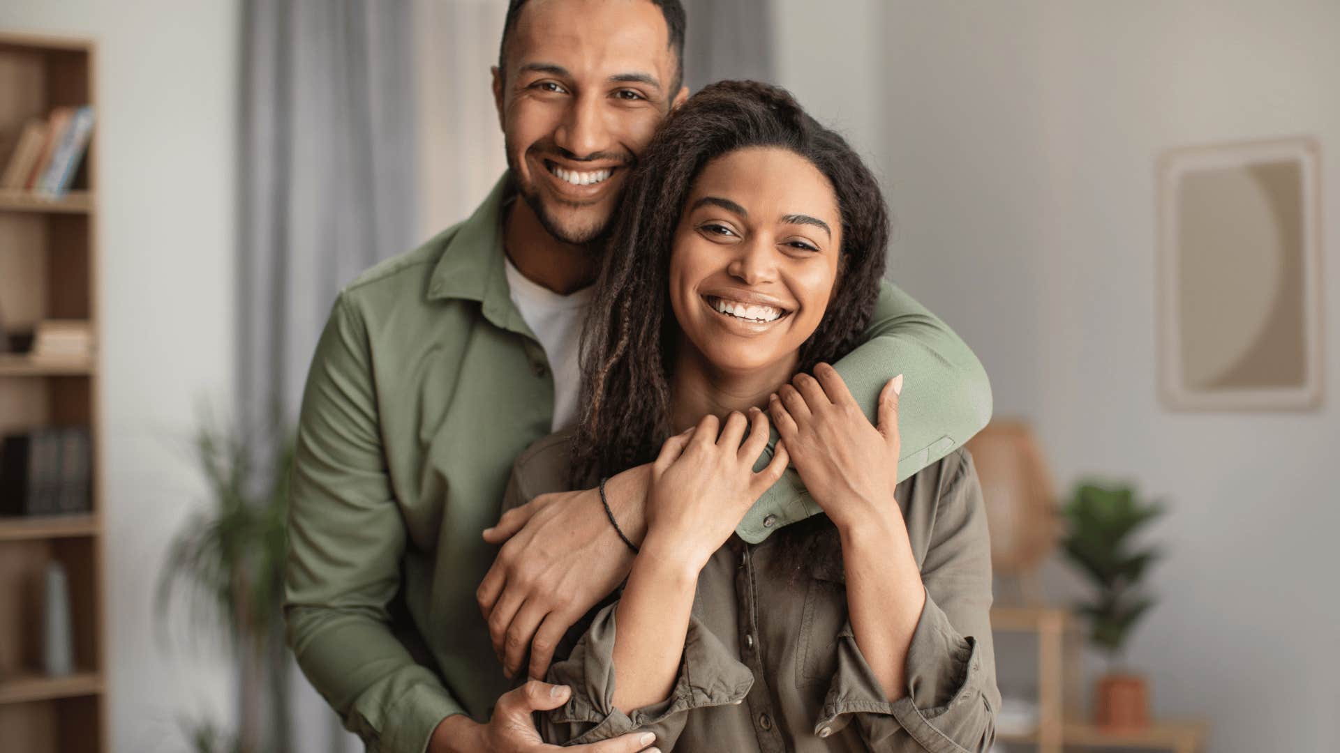 man hugging woman from behind