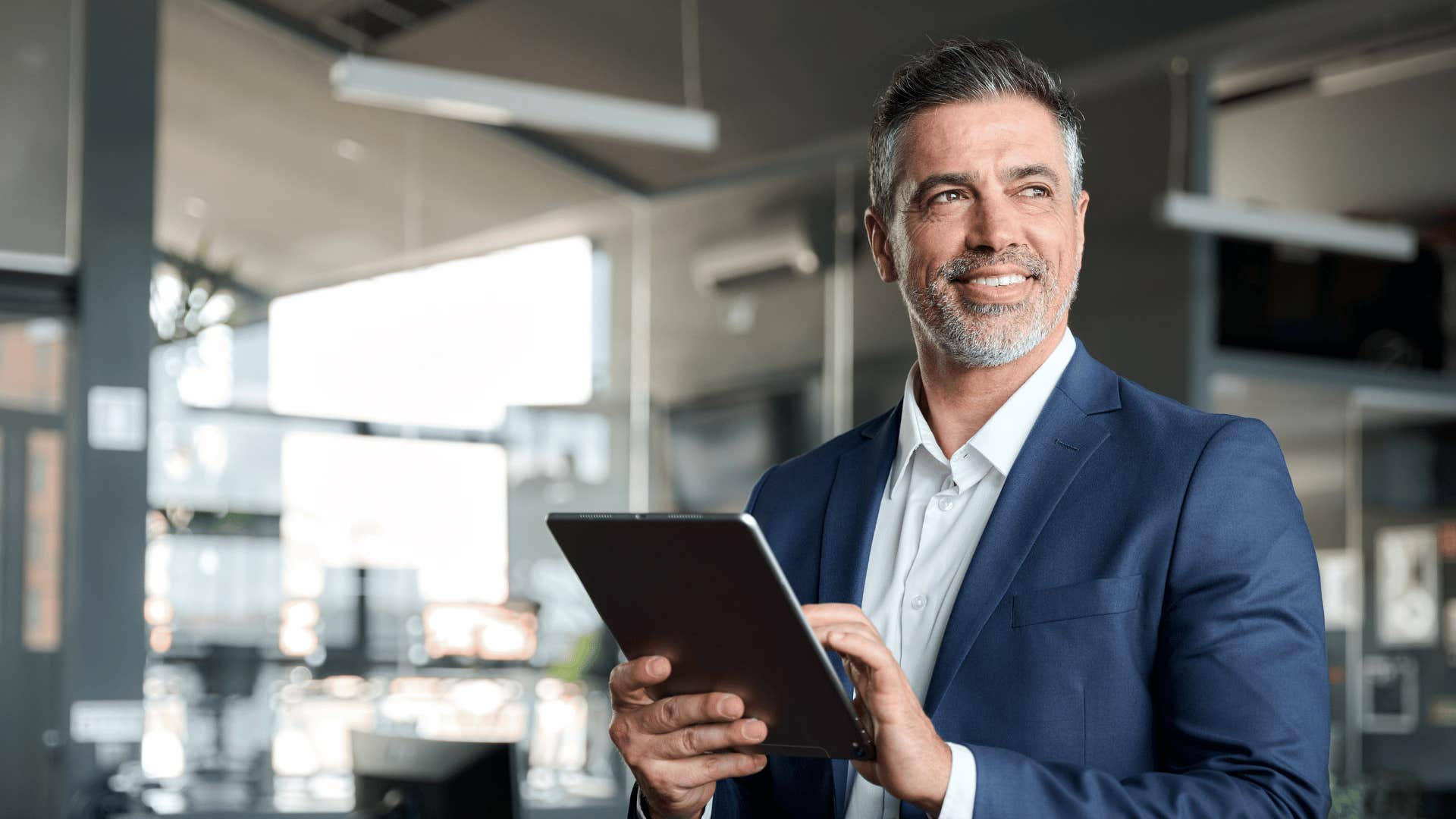 man holding tablet and smiling