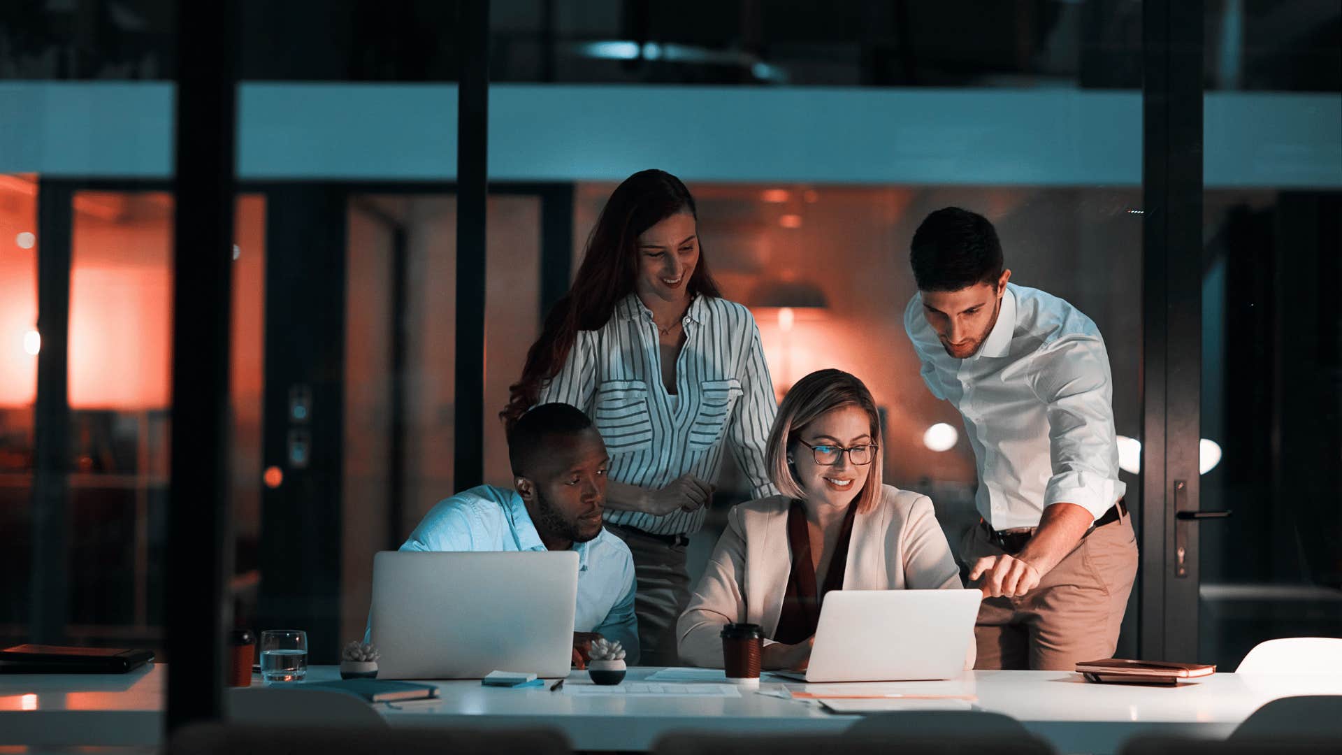 group of people working on laptop