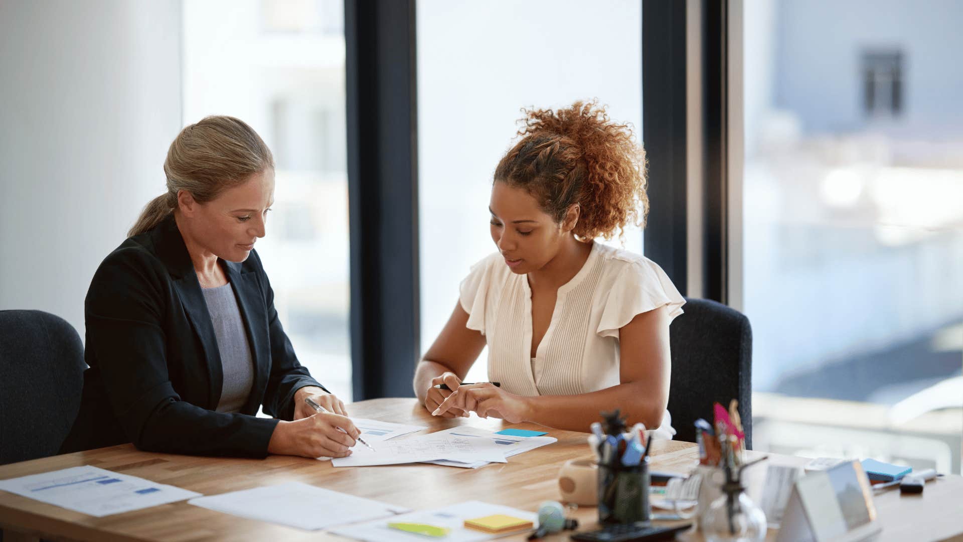 women looking at documents