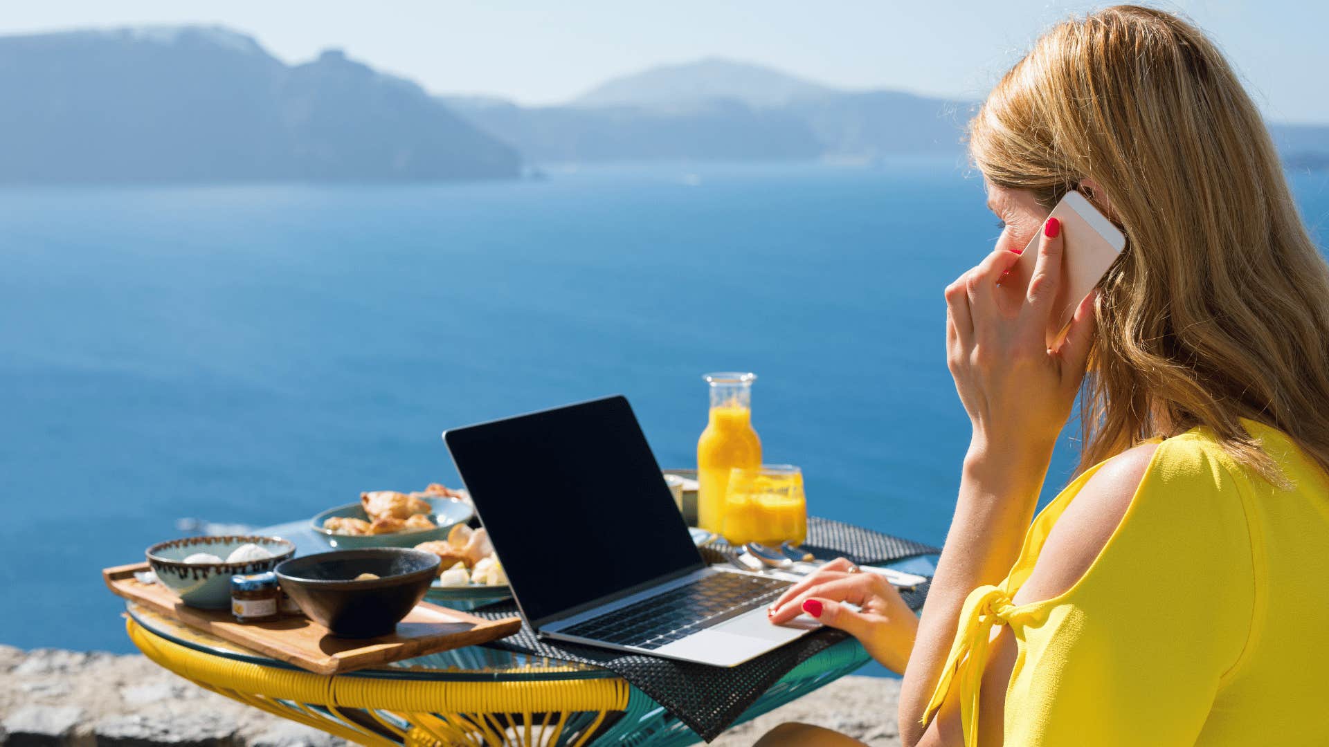 woman working on laptop in tropics