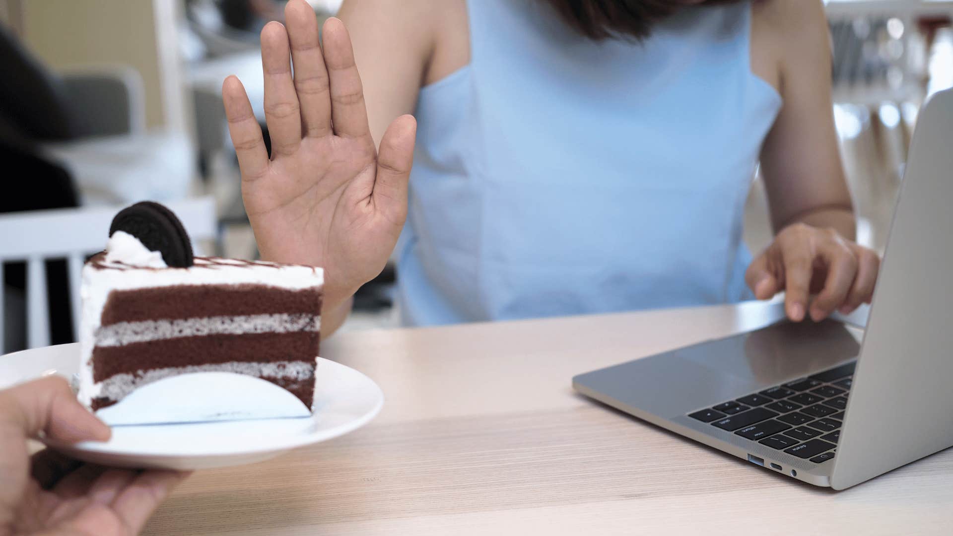 woman saying no to cake