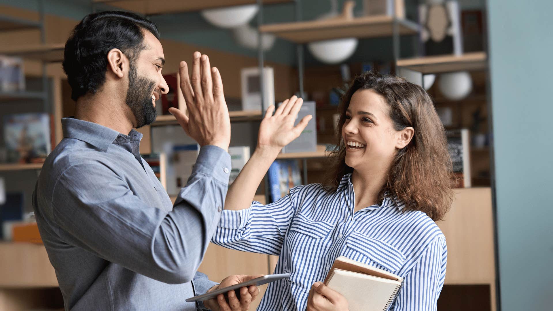 two people high-fiving