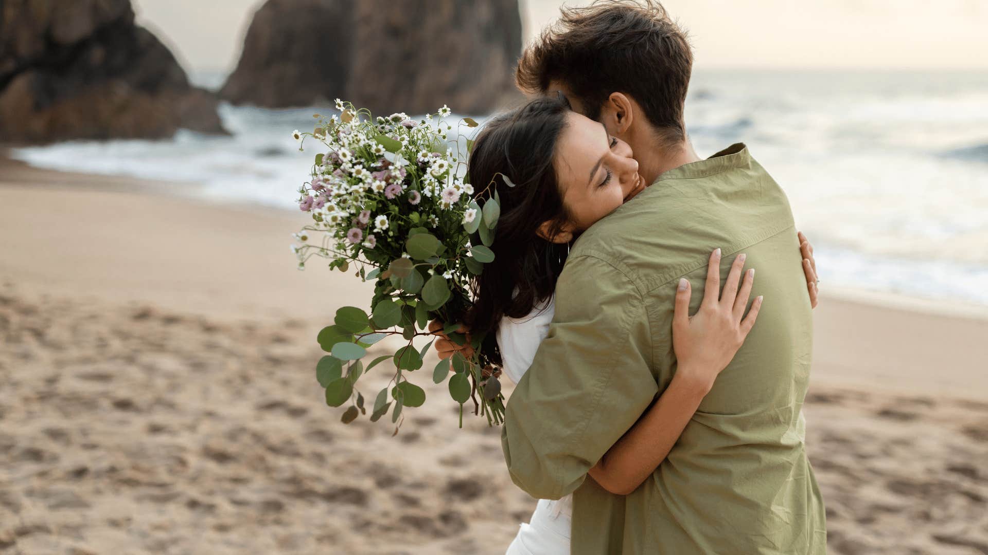 couple with flowers on beach