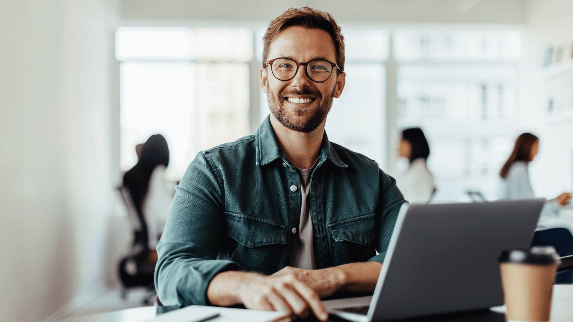 smiling man working on computer