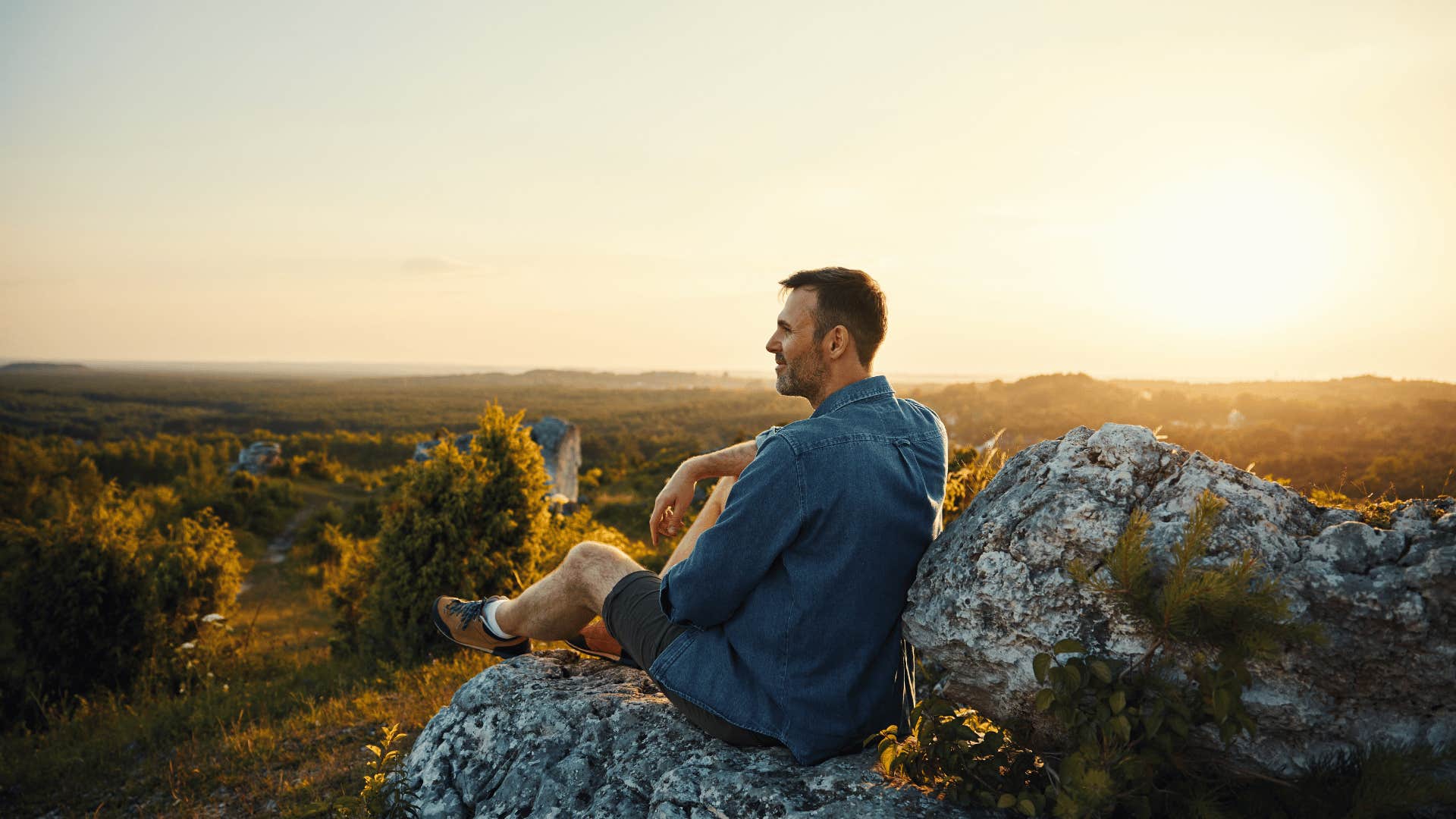 man watching sunset outside