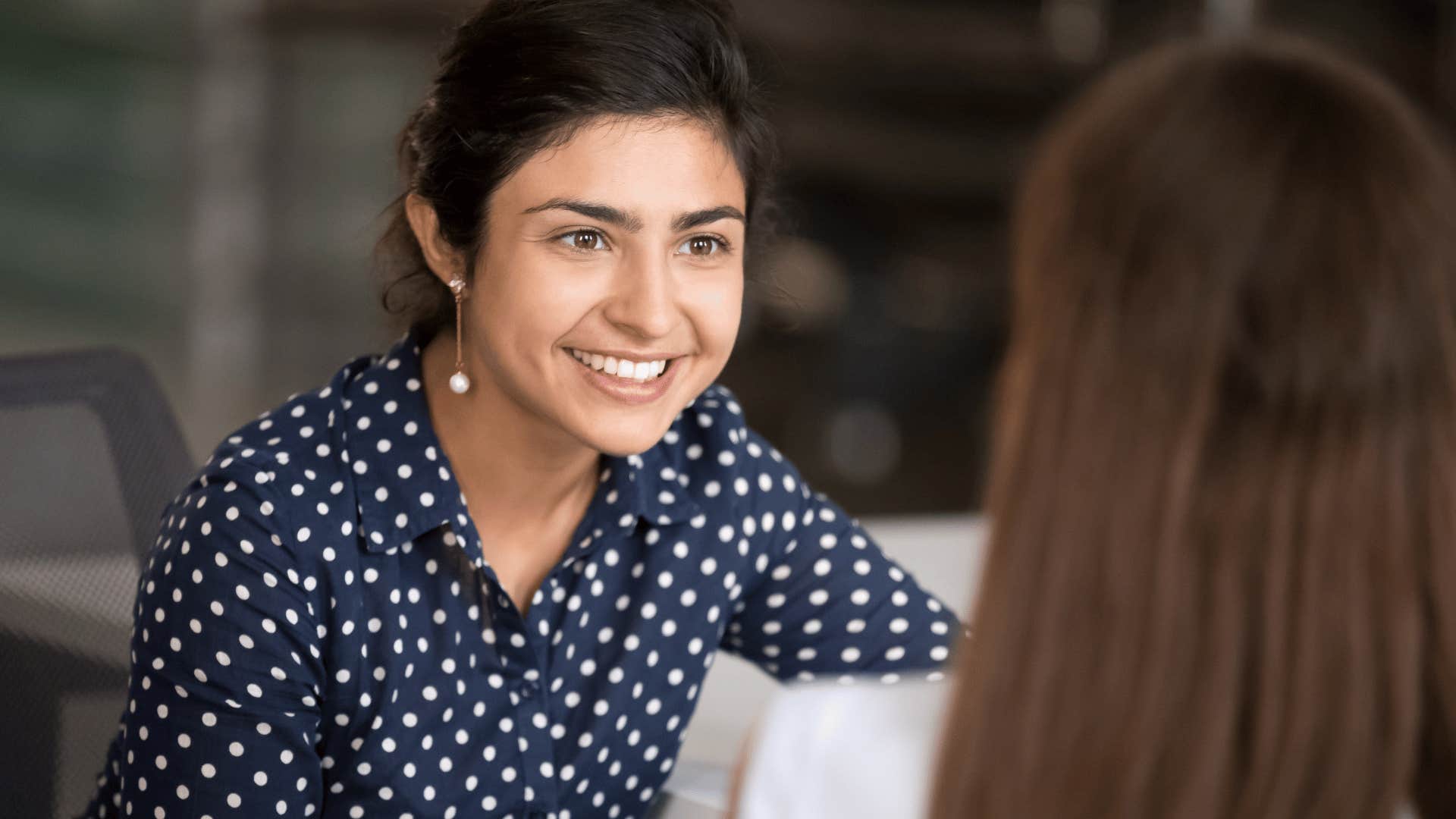 woman smiling while listening