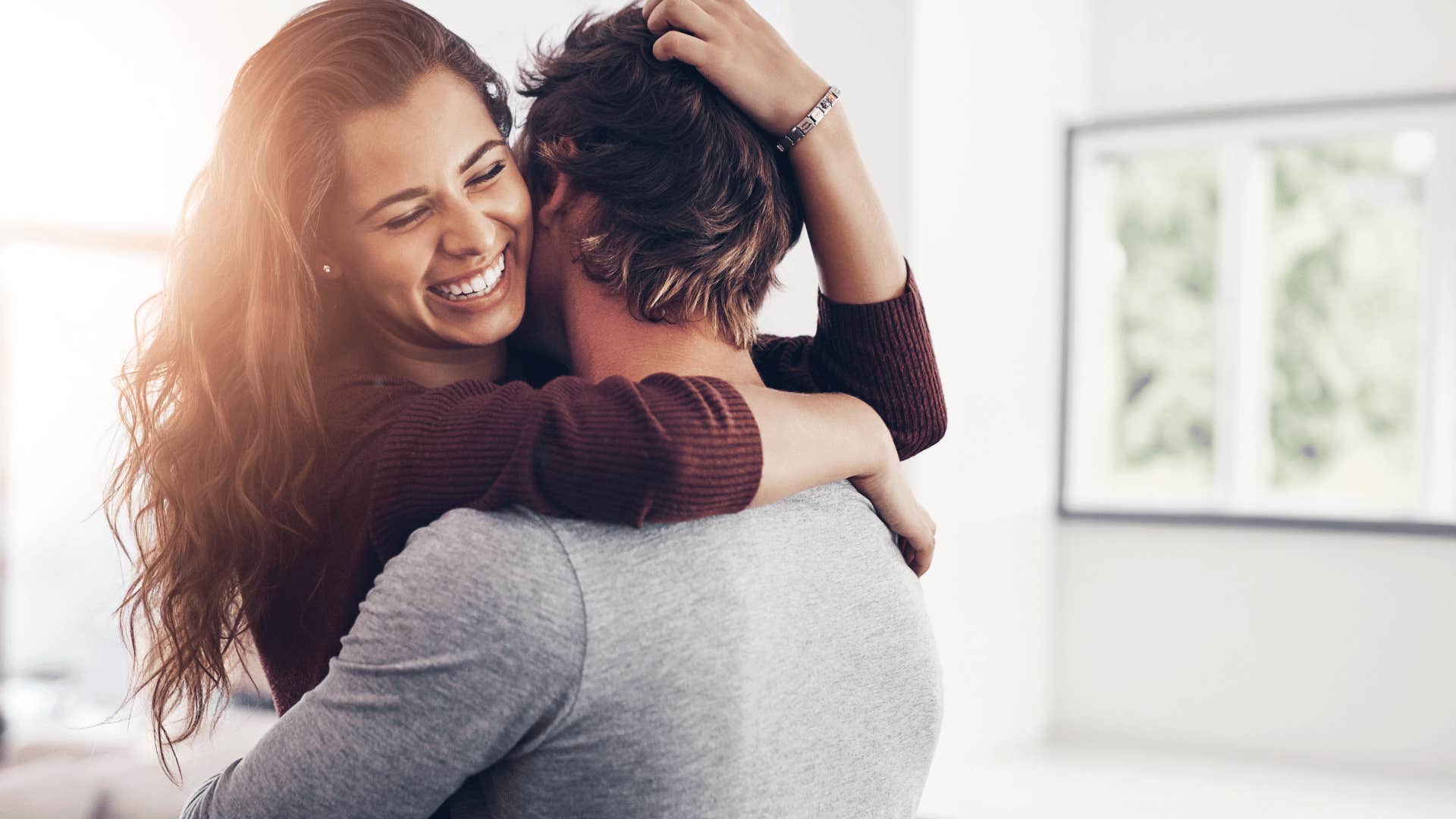 man hugging woman