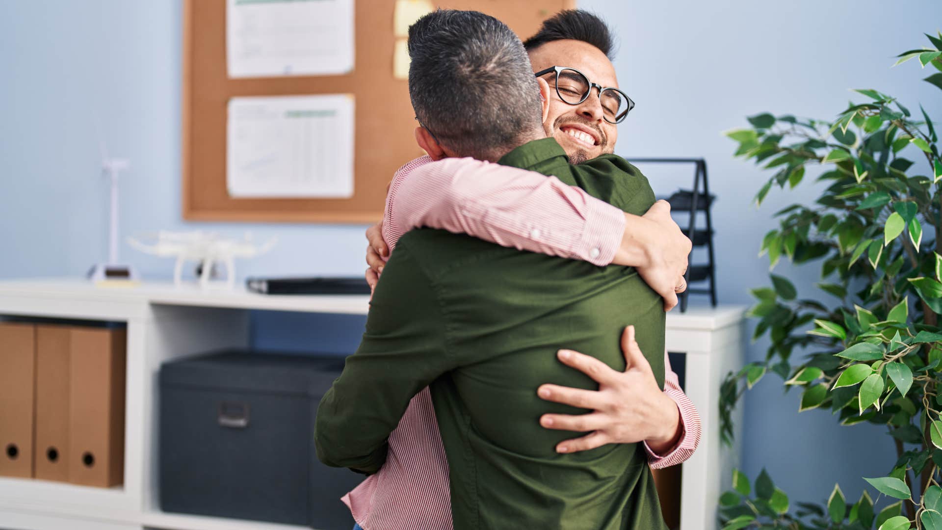 two empathetic men hugging