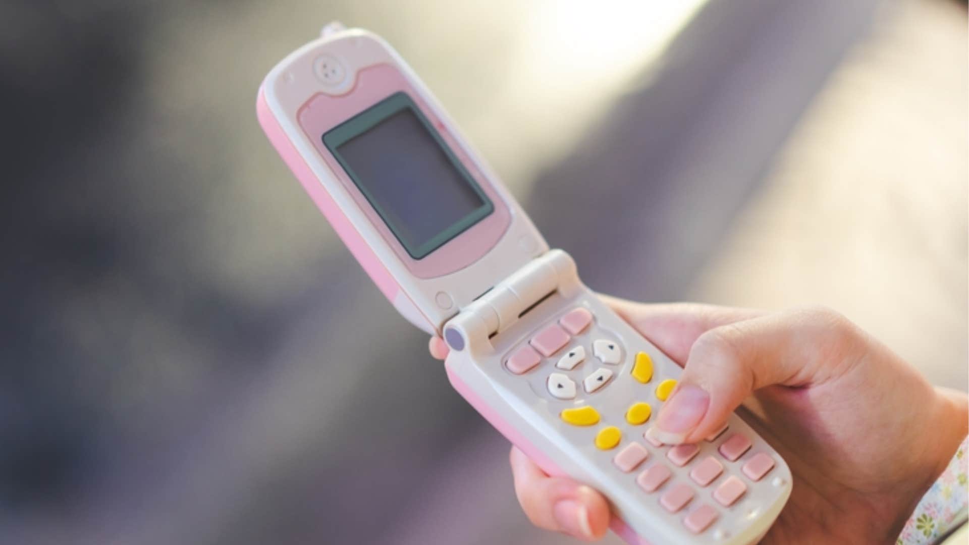 young girl using flip phone