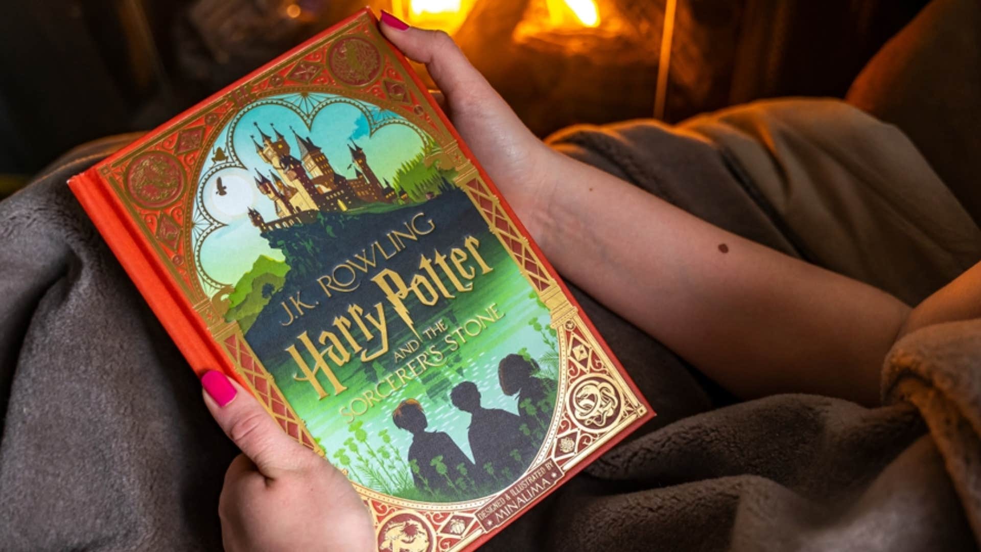 girl holding harry potter book on her lap