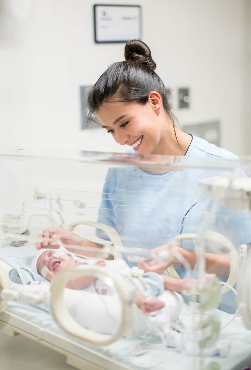 mom smiling at NICU baby