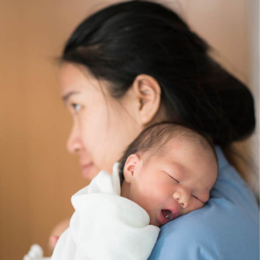 mom holding newborn baby 