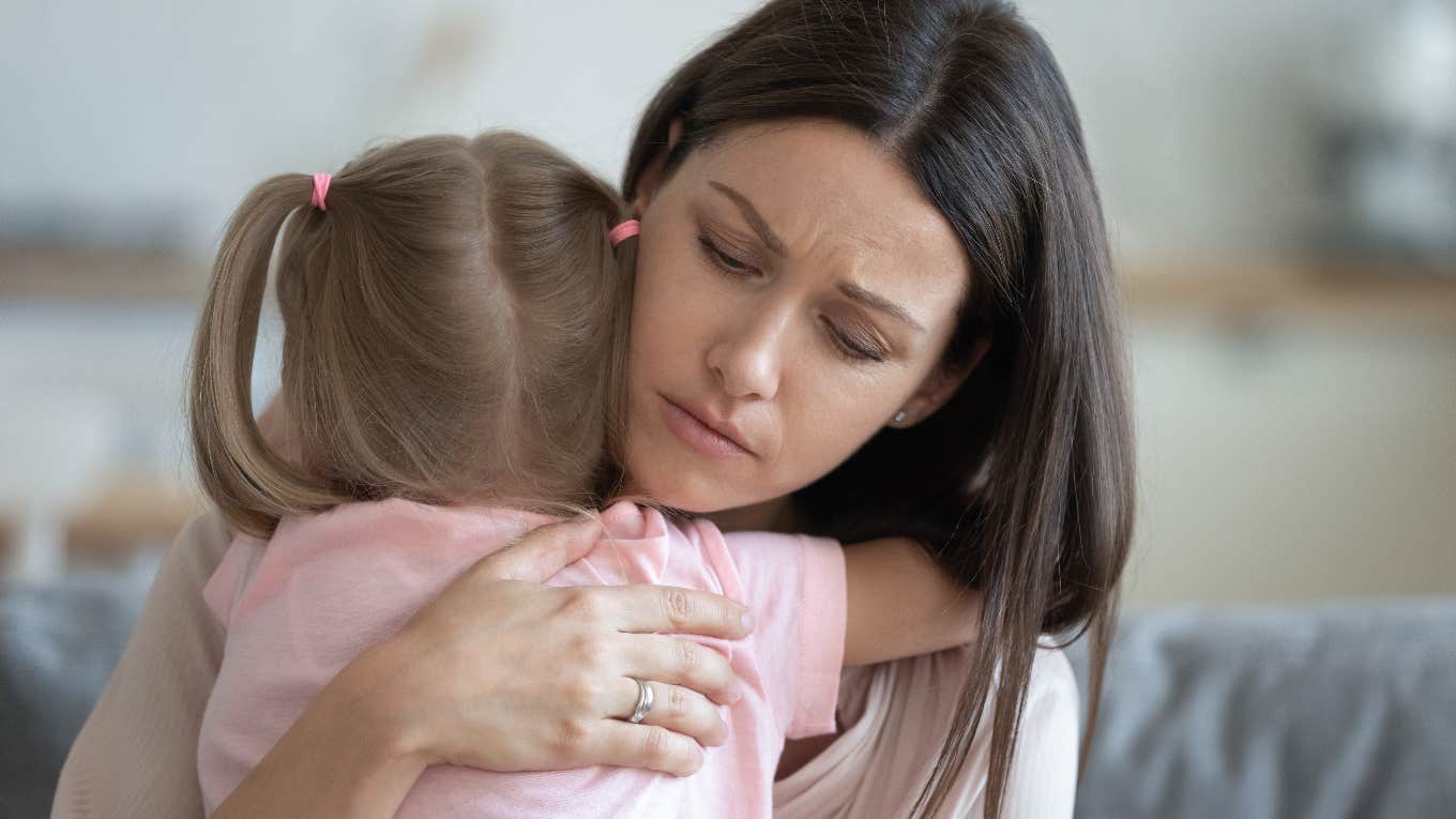 Mom comforting her daughter who wasn't invited to a party