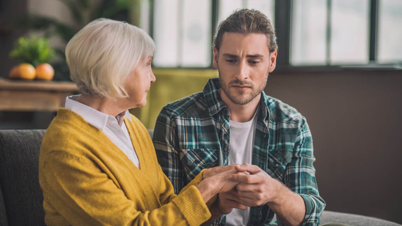 mom holding son's hands during serious conversation