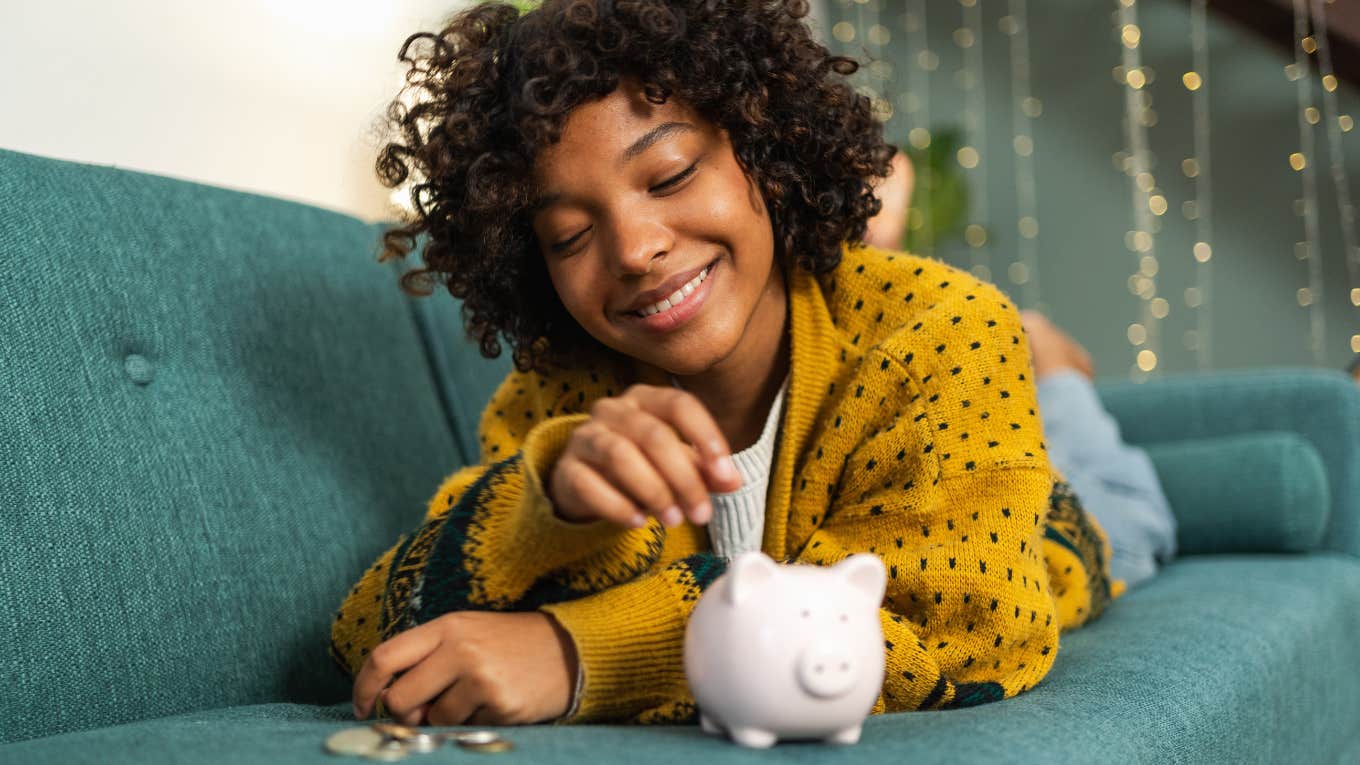 Woman putting change into a piggy bank