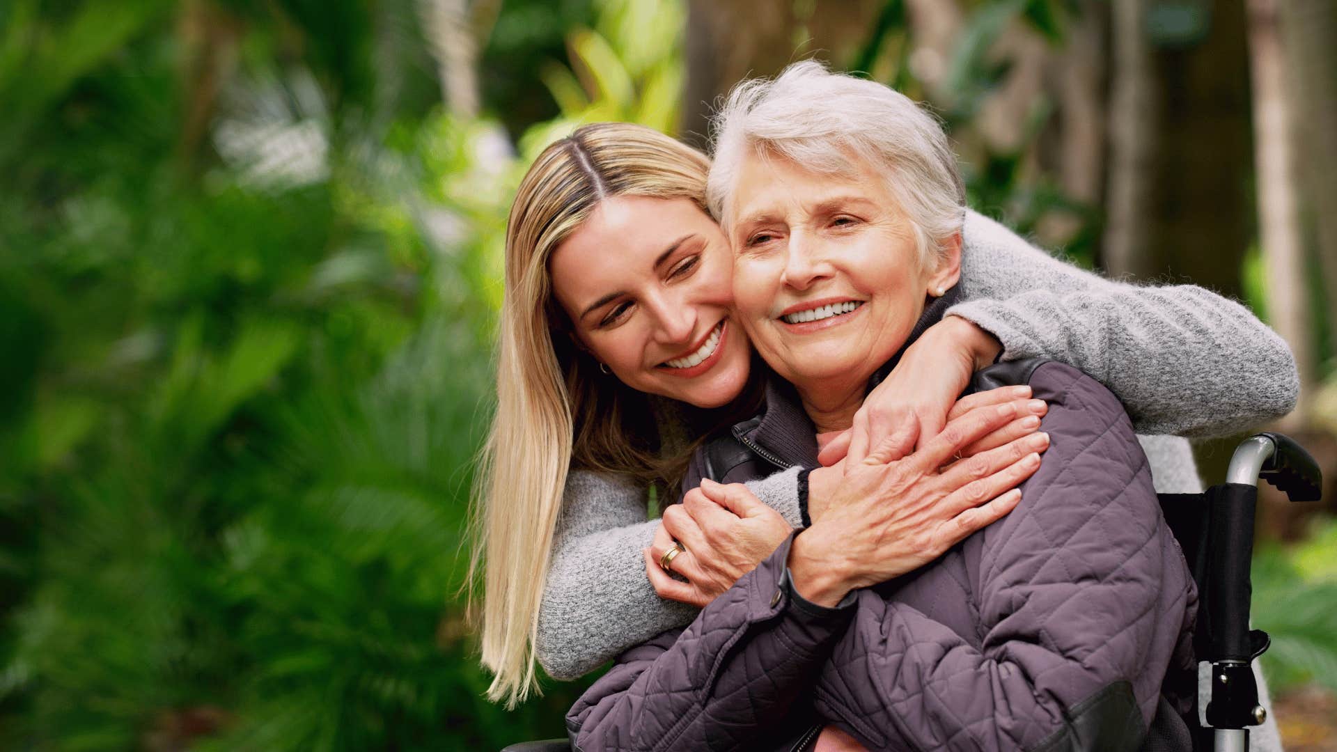 woman hugging older woman in a wheelchair