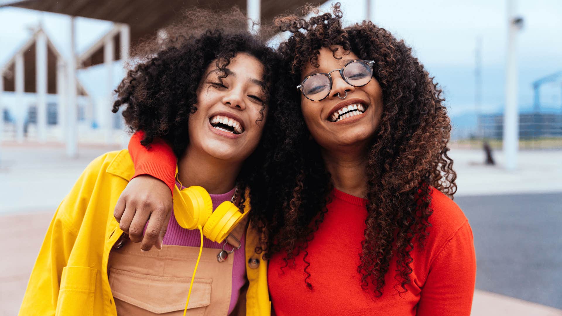 two female friends smiling and hugging