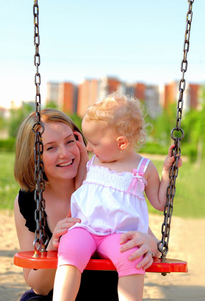 Nanny with a kid on the playground