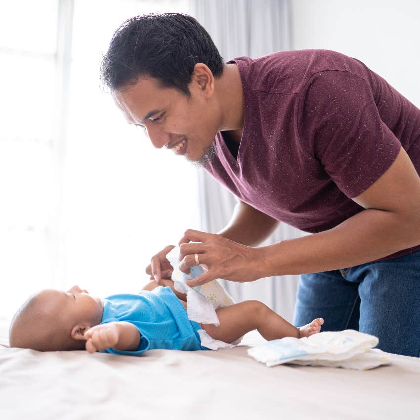 New dad changing baby's diaper