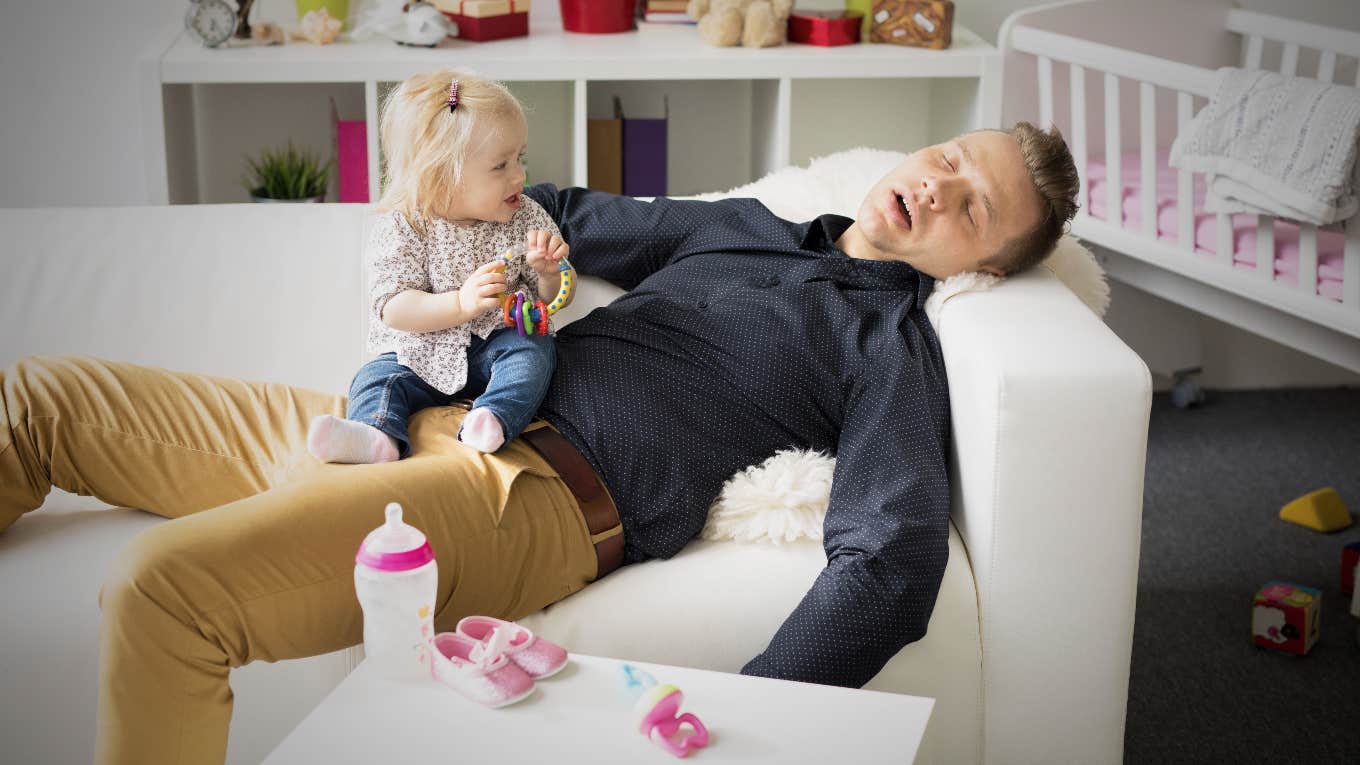 Dad asleep with baby on his lap