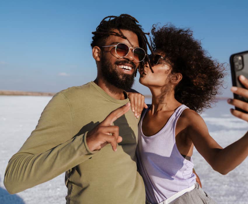 confident happy couple takes selfie on the beach