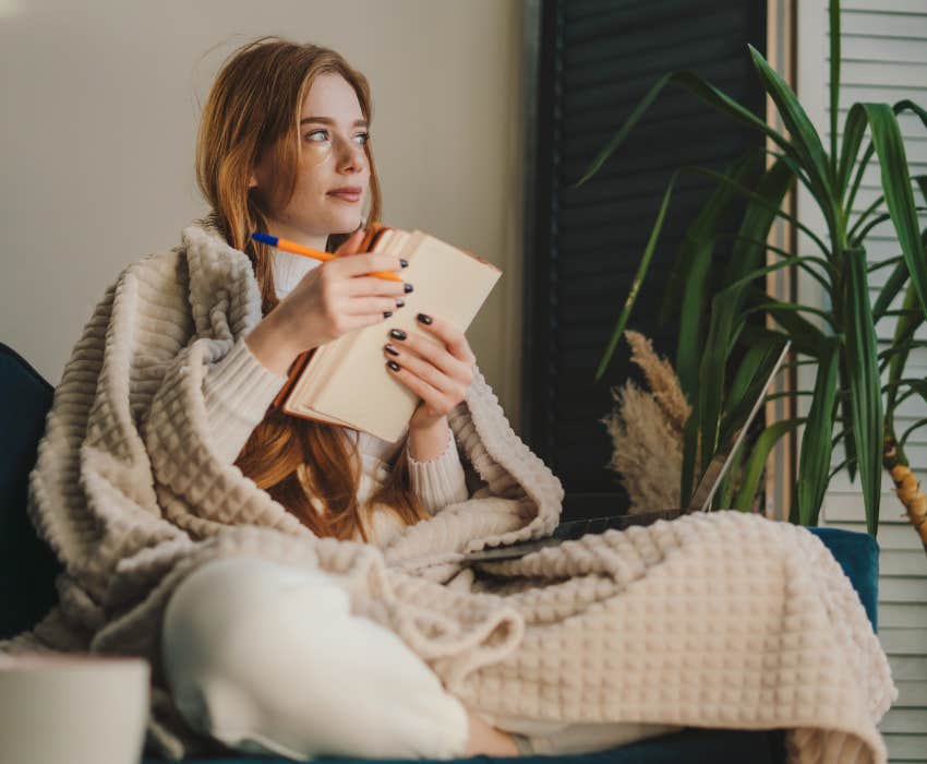 woman with red hair writing with good grammar 