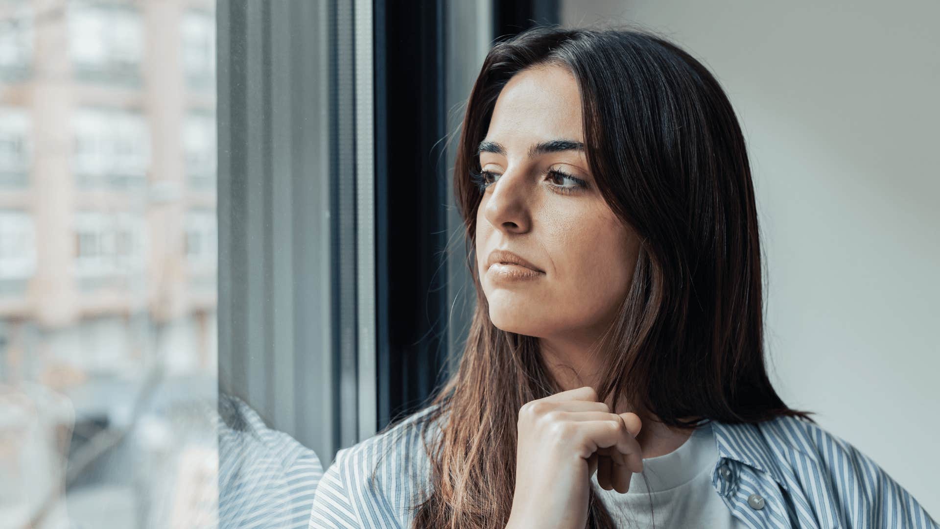 woman staring out the window reflecting