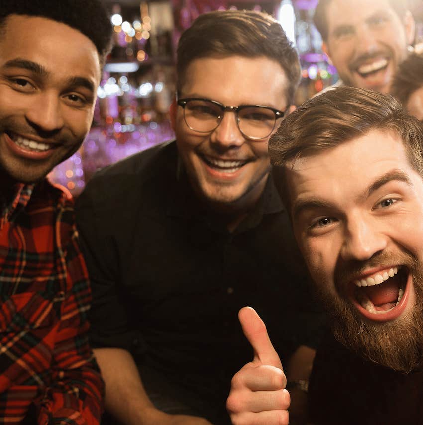 Group of enthusiastic men get ready to do ridiculous stunt in bar