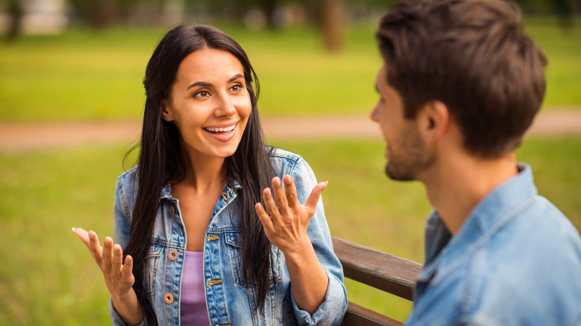 intelligent woman talking to man on bench