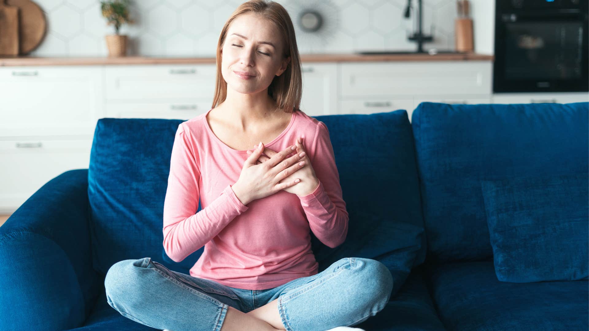 self-aware woman sitting peacefully on couch