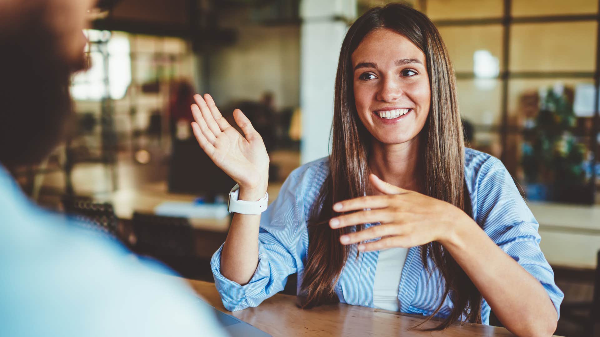 Woman smiling and talking with her hands.