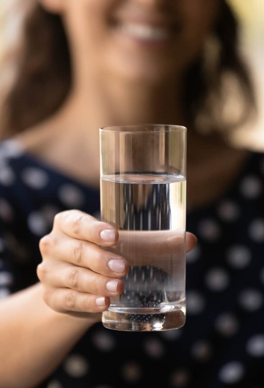 Host offering a glass of water guest house