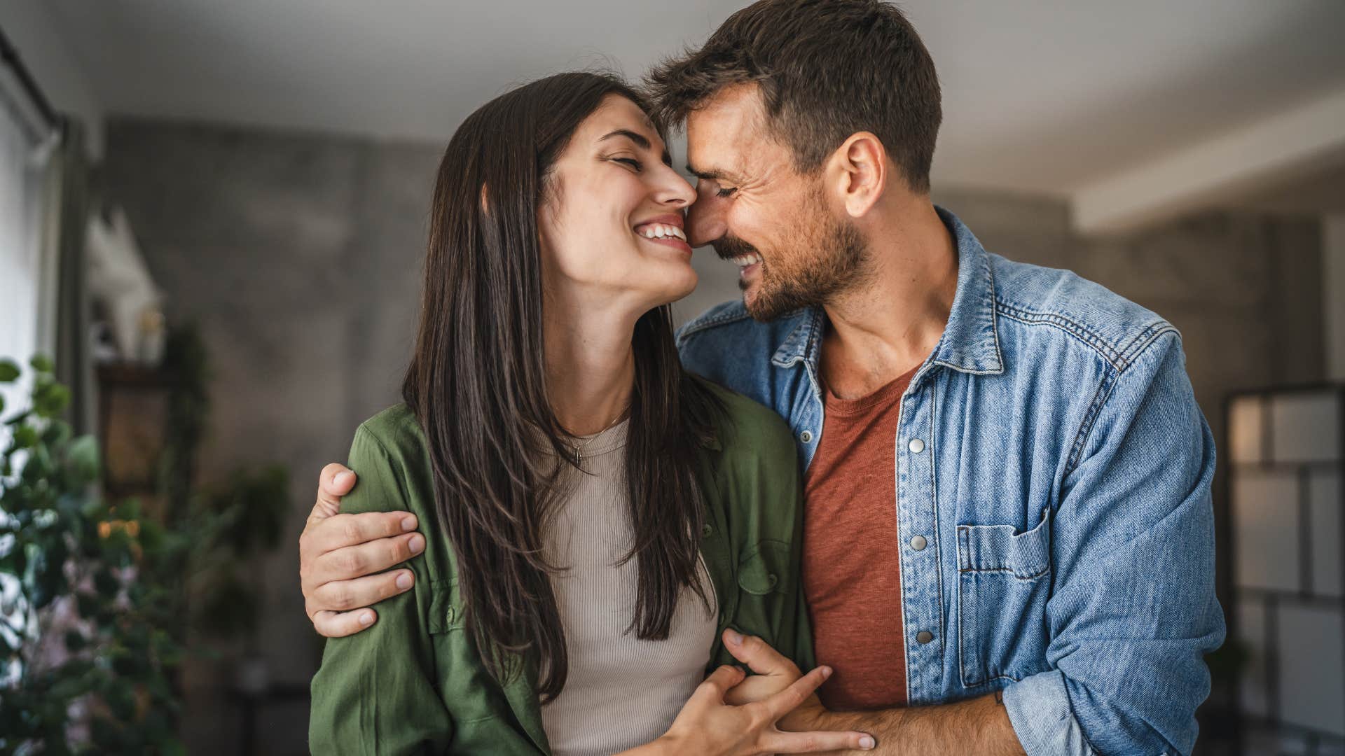 Man smiling and hugging his happy wife.