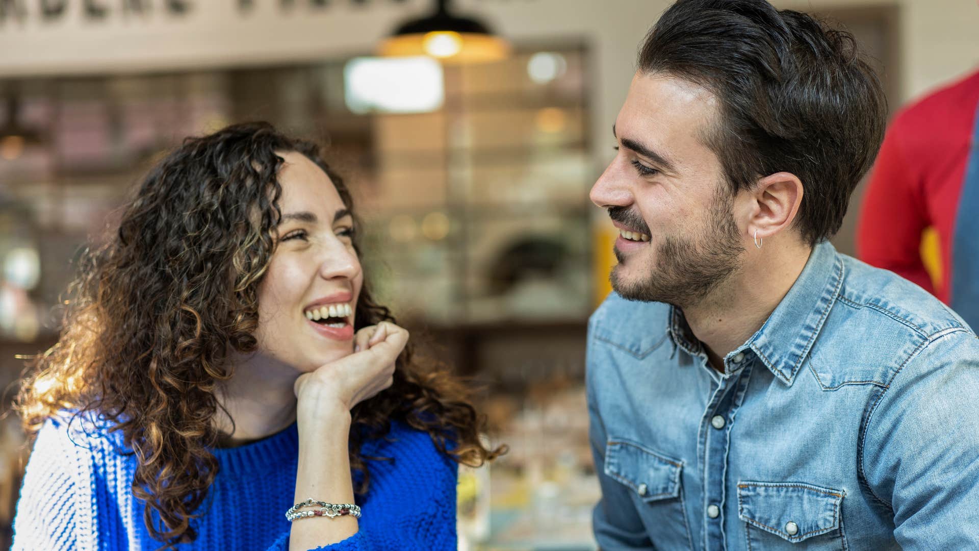 Couple smiling and talking together.