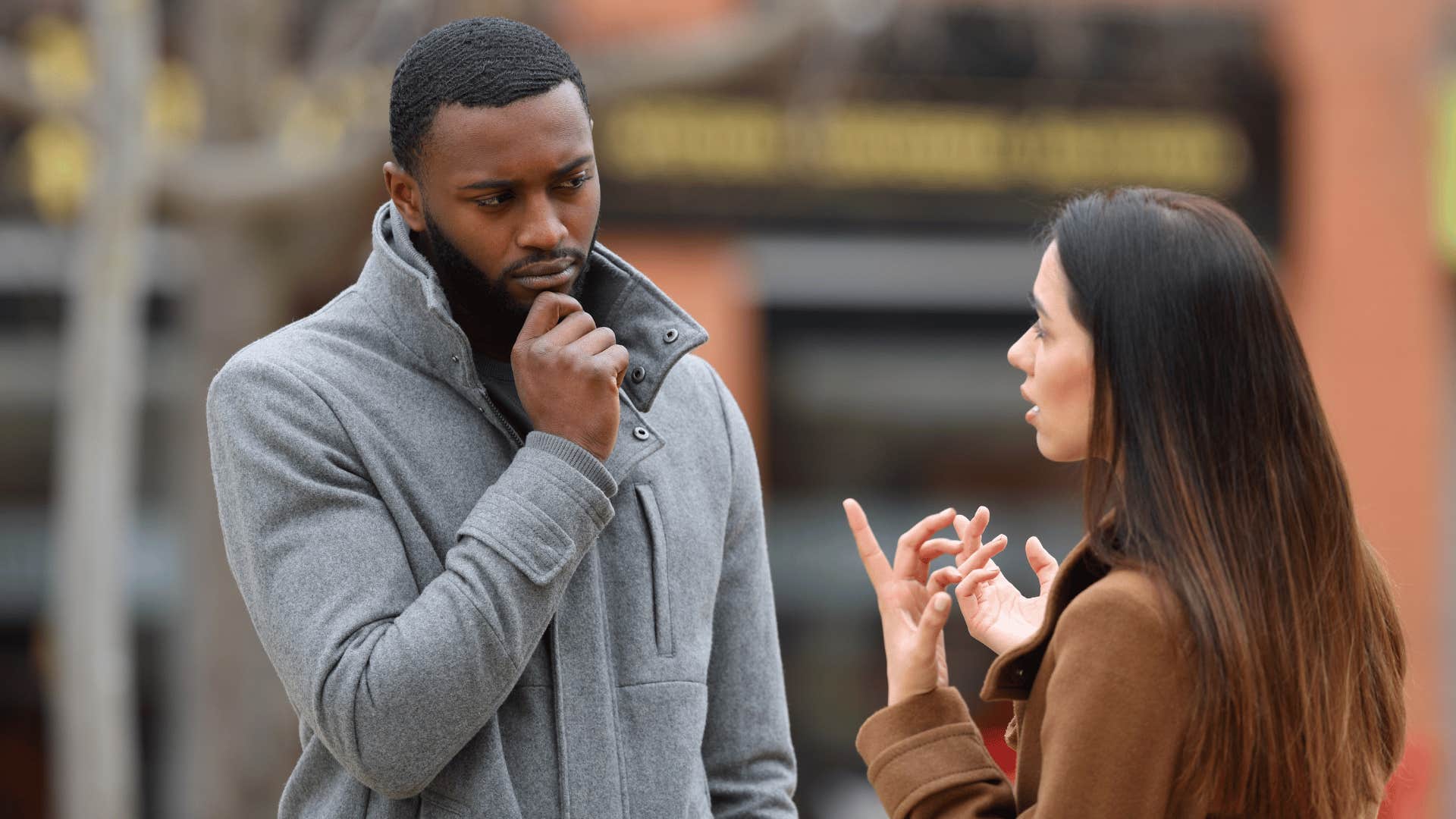 man listening as woman talks