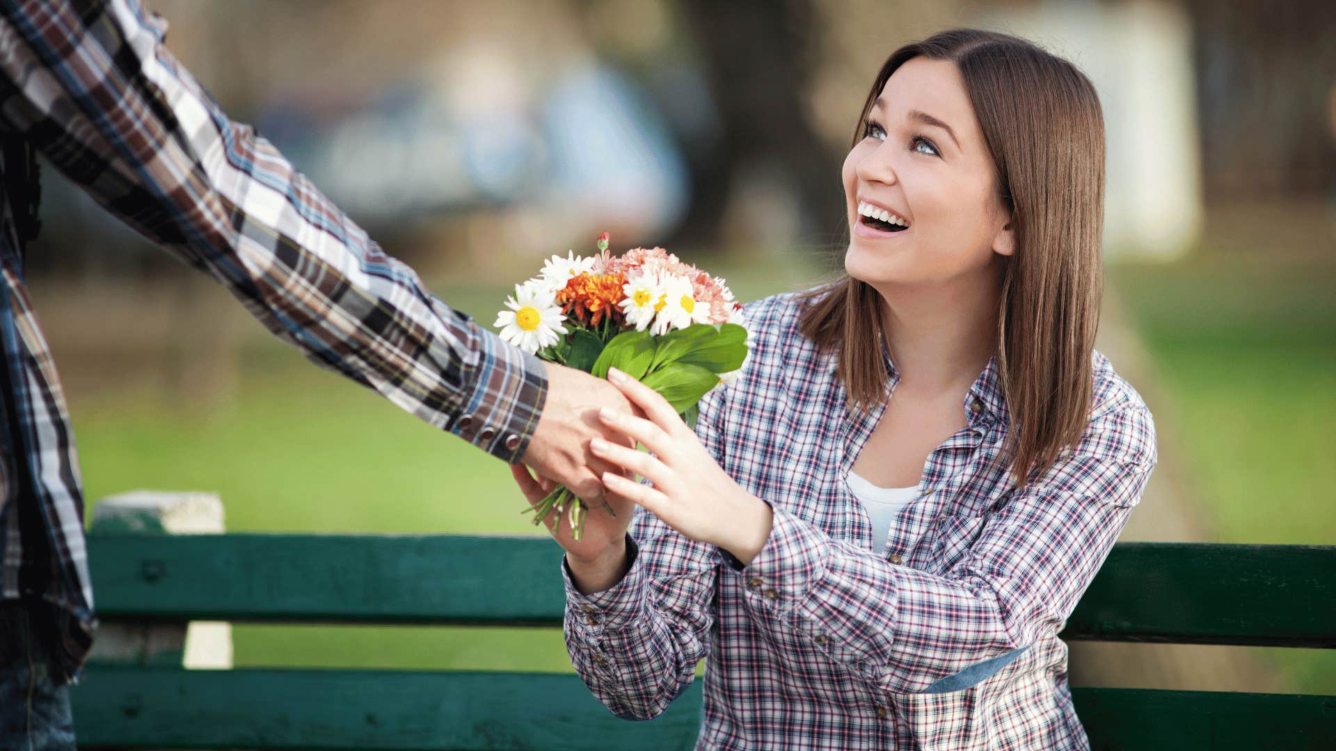 man giving woman flowers