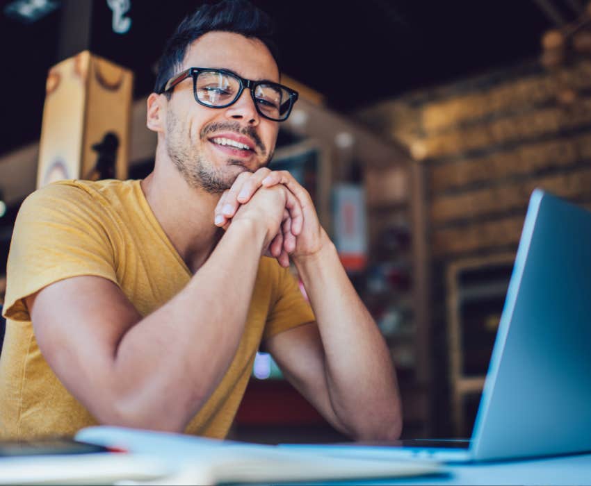 man working remotely with laptop sitting at table and during break