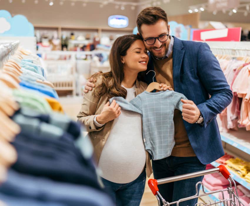 middle age couple enjoying in buying clothes and appliances for their new baby.