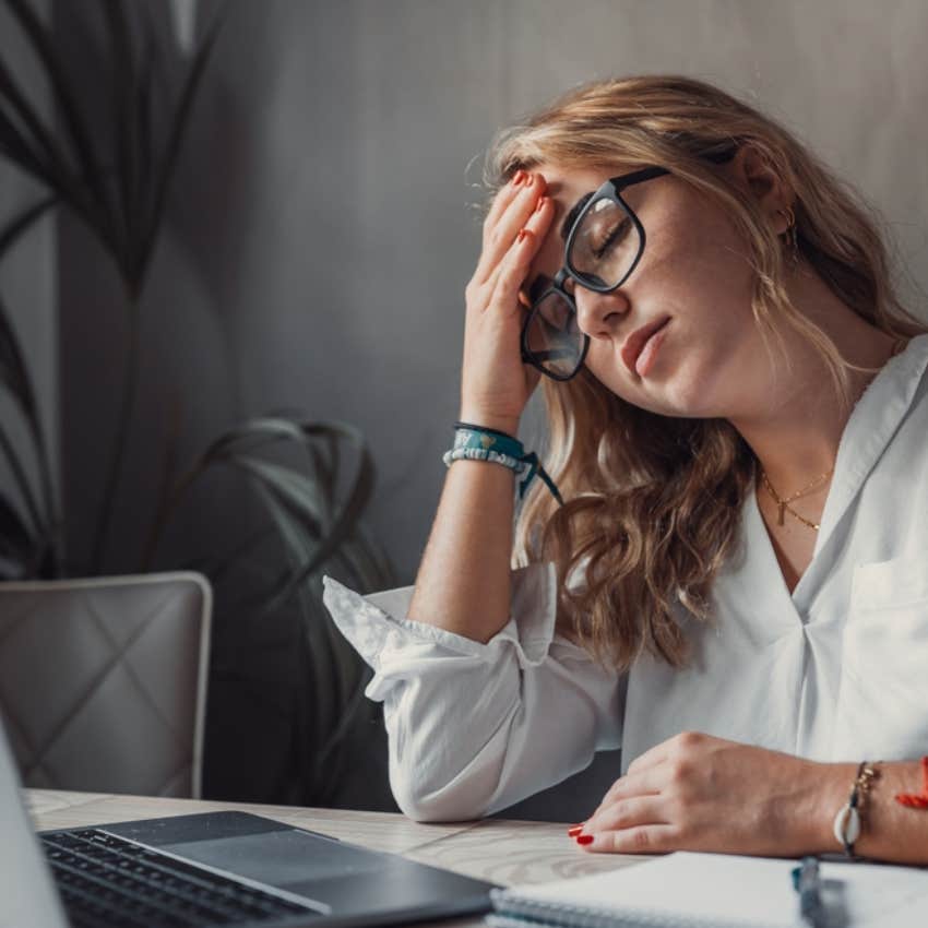 exhausted woman by computer 