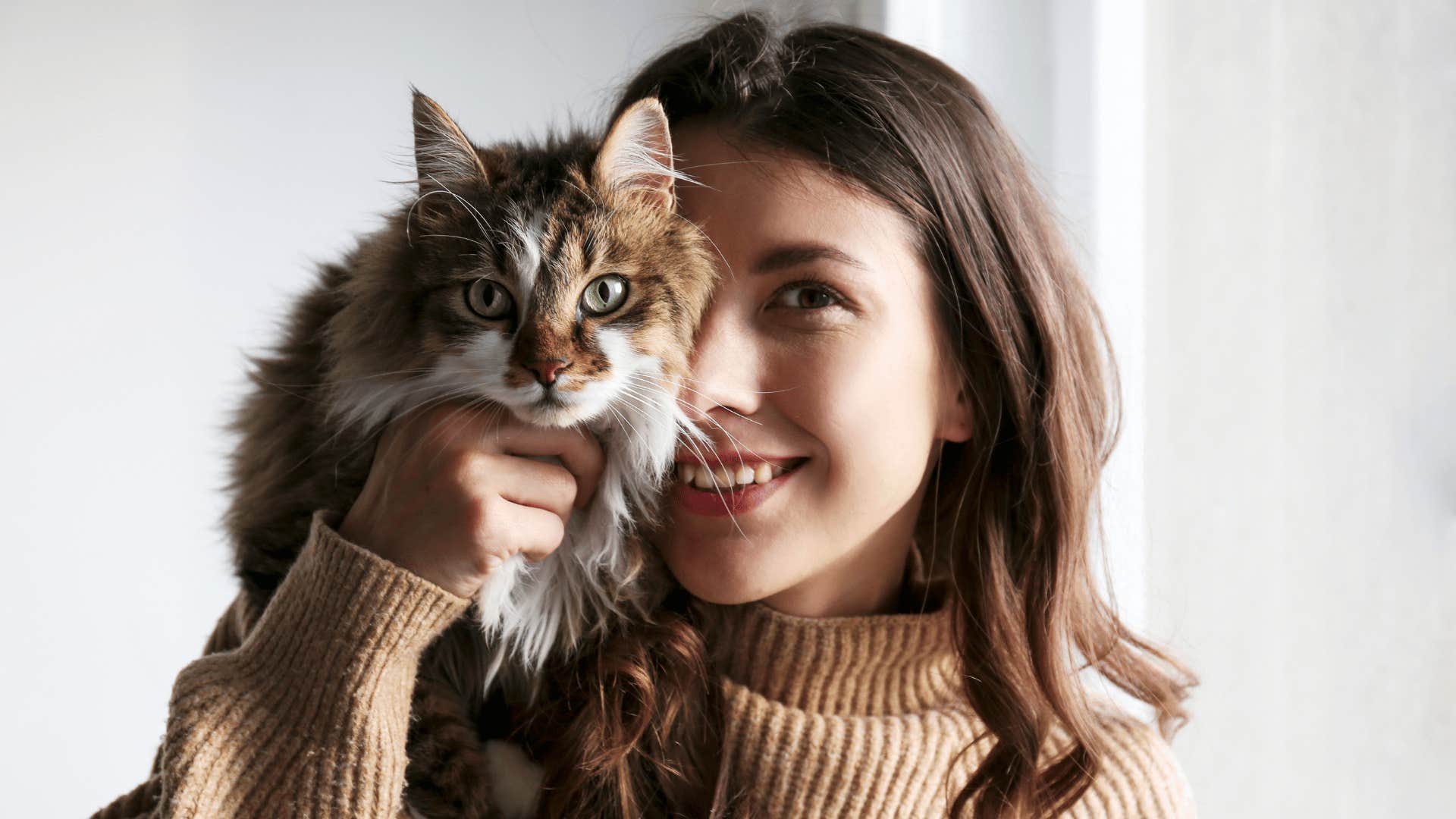 independent woman holding a cat