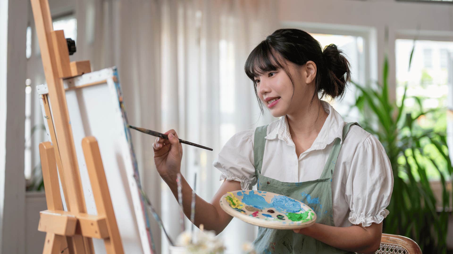 woman painting on a canvas