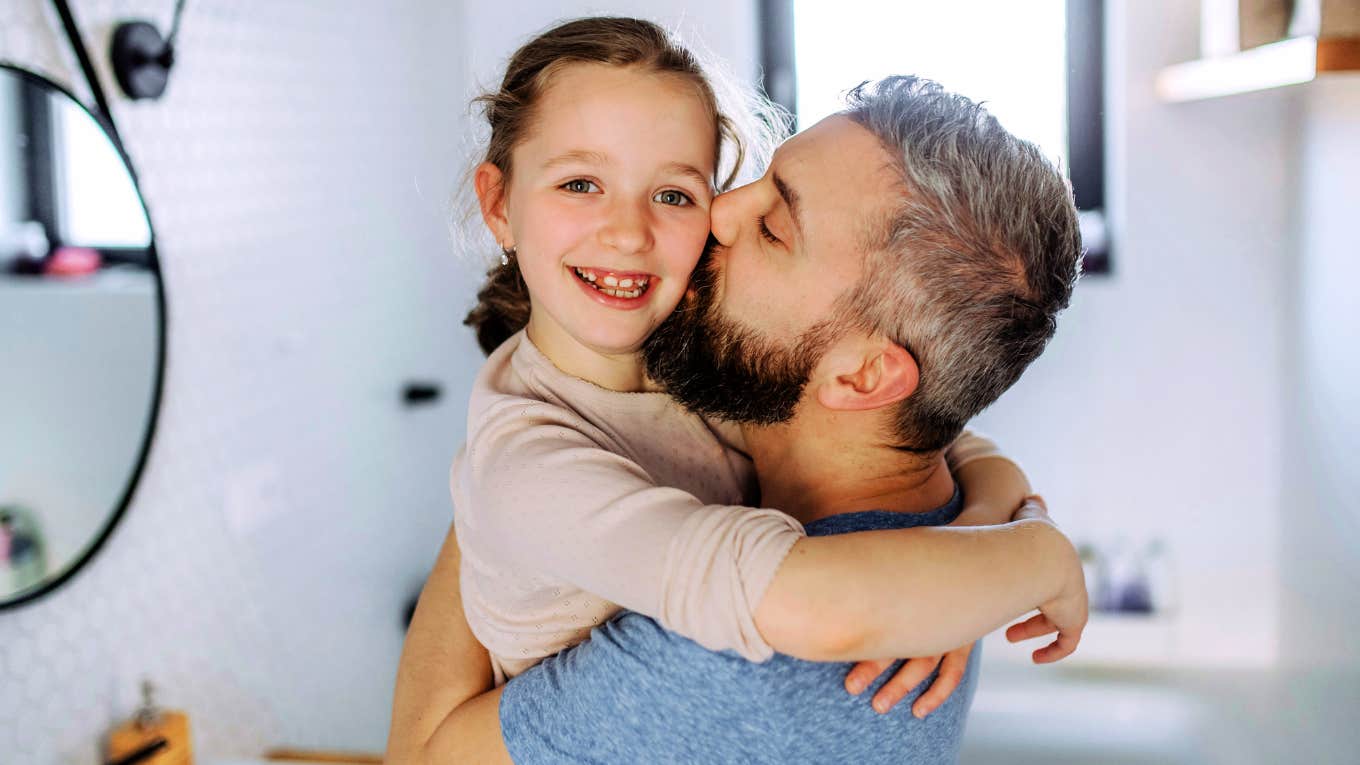 Parent Hugging child, teaching her how to become a very calm adult. 