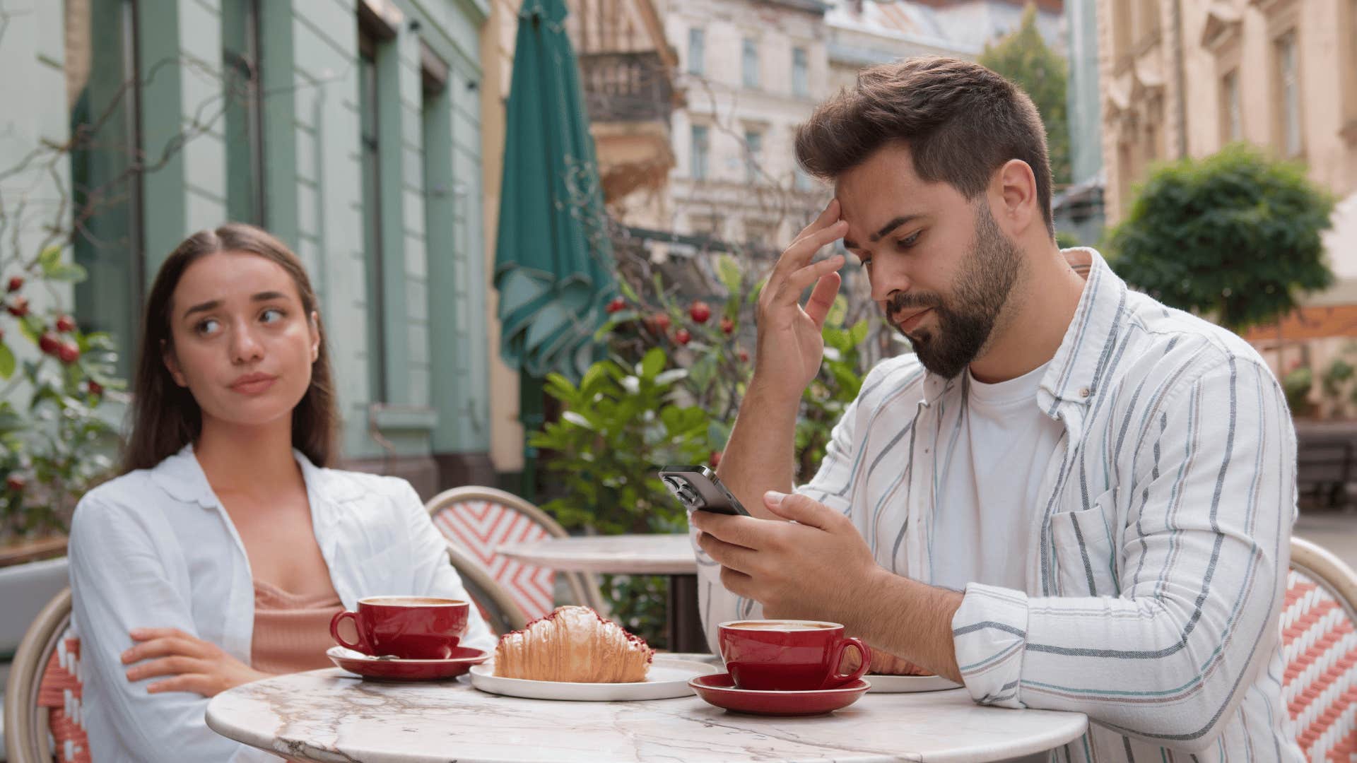 man ignoring woman on a date