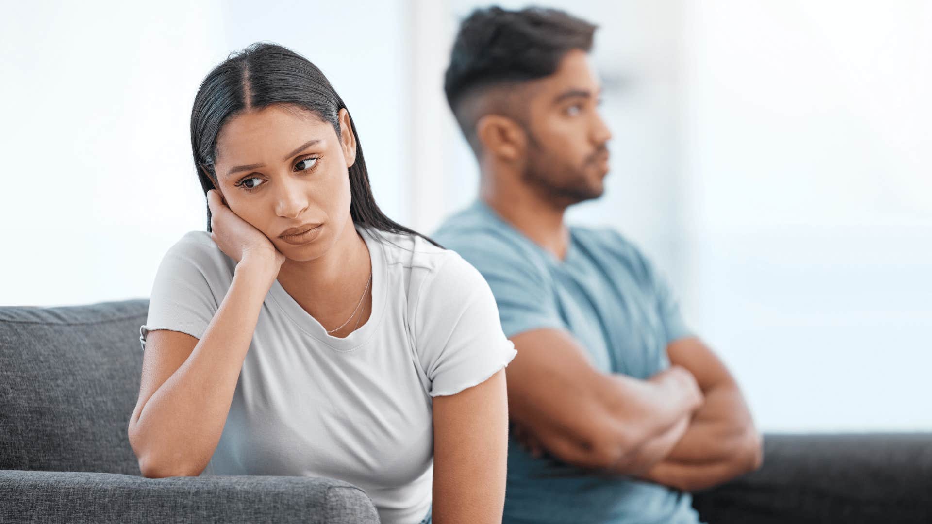 upset couple sitting on couch