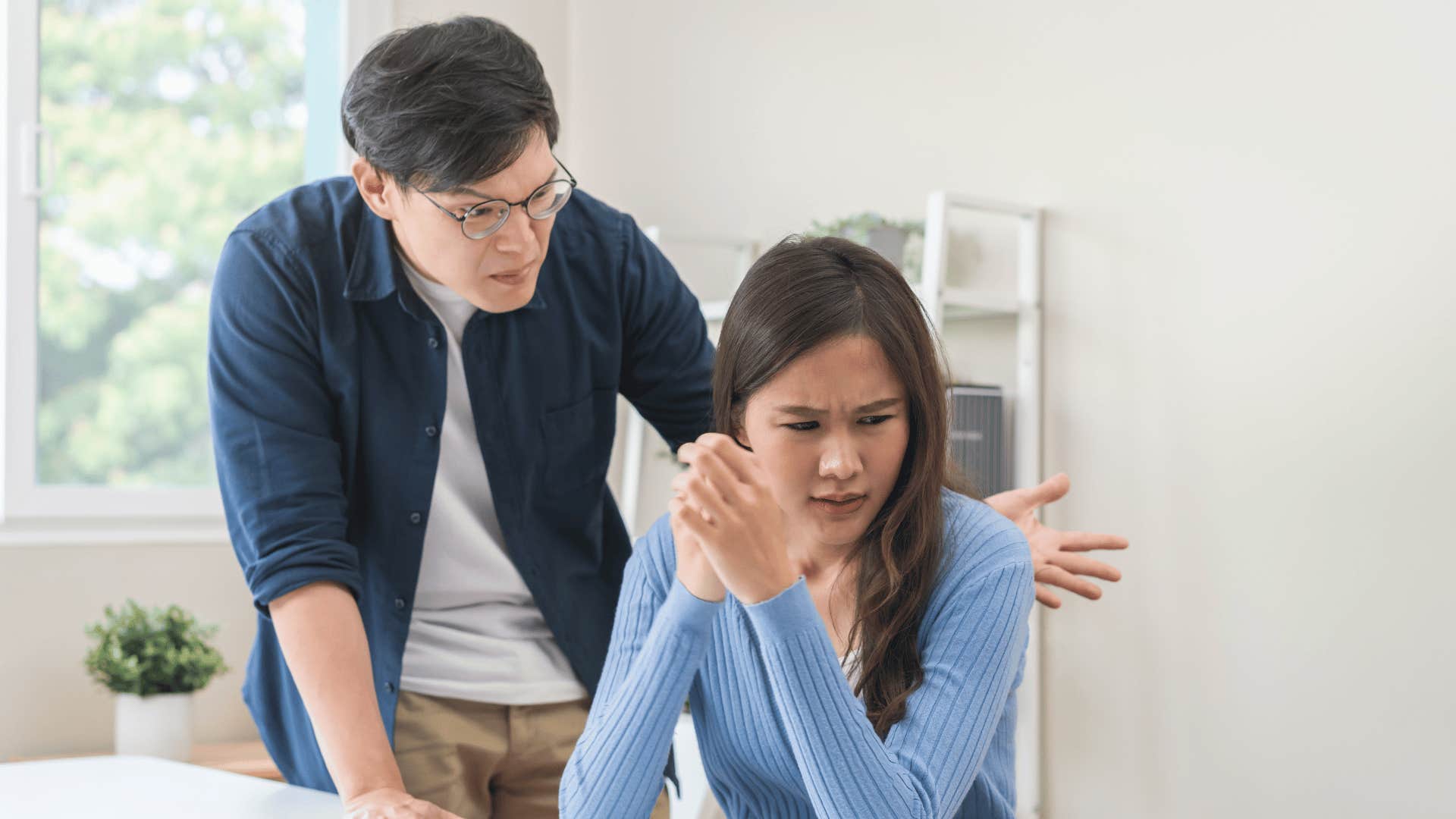 man arguing with woman who has her back to him