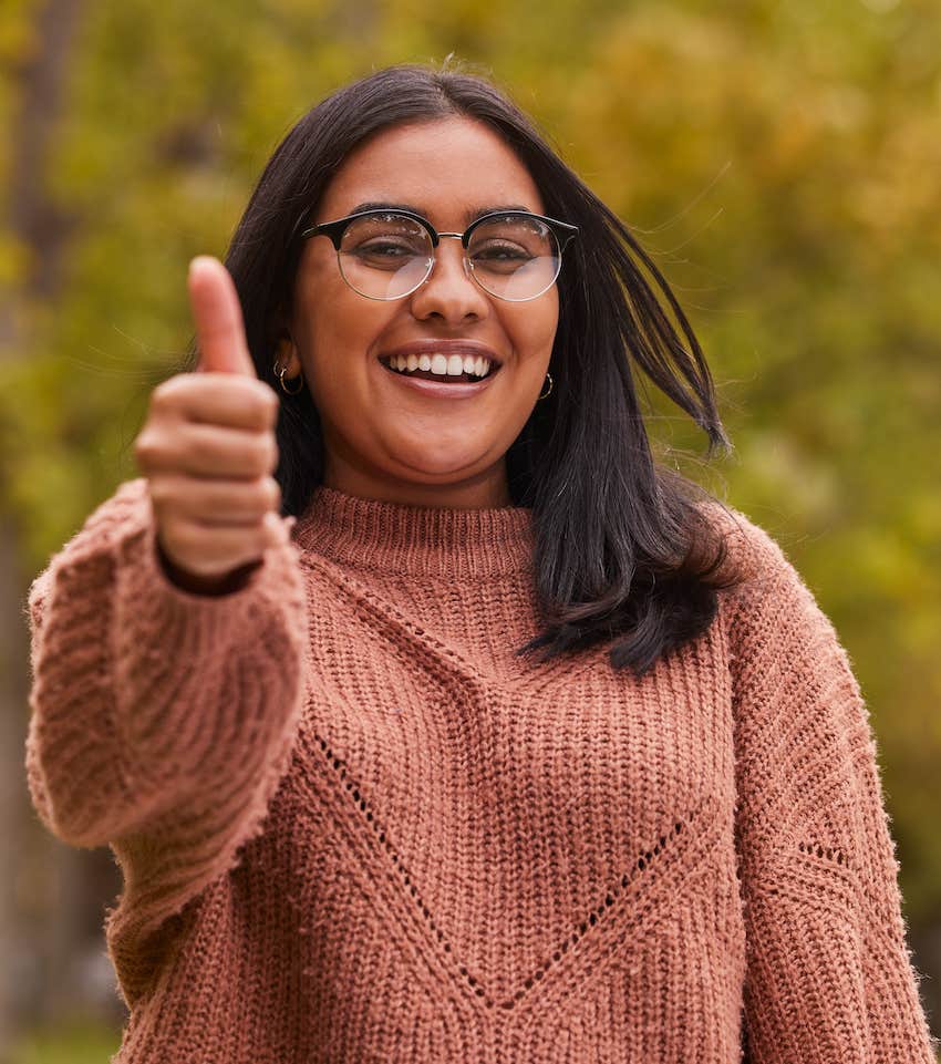 Confident woman gives a thumbs up